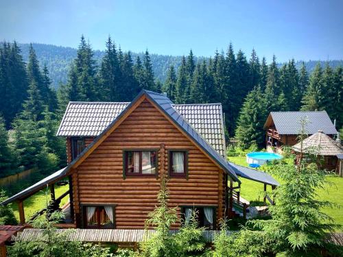 una baita di tronchi in mezzo a una foresta di Cottage Lavanda окремий котедж з каміном a Bukovel