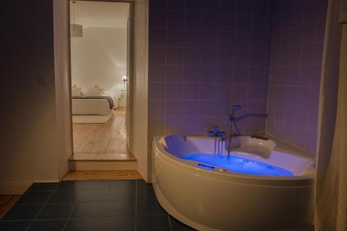 a bathroom with a tub with a sink and a shower at La Saudade in Saint-Péray