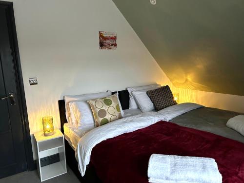 a bedroom with a bed and a table with a lamp at Pristine Flat Within Heart Of Worthing in Worthing