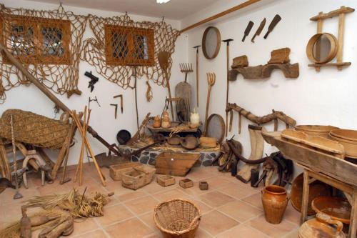 a room filled with lots of wooden items on the wall at Checkmate in Tolox