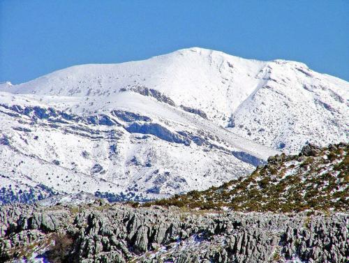 a mountain covered in snow with a mountain at Checkmate in Tolox