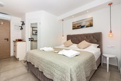 a bedroom with a large bed with two pillows at House Feral (Vis center) in Vis
