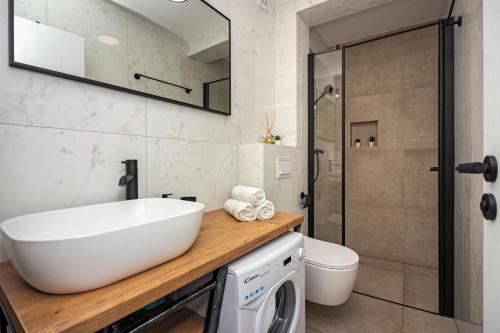 a bathroom with a sink and a toilet at House Feral (Vis center) in Vis