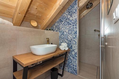 a bathroom with a white sink and a shower at House Feral (Vis center) in Vis