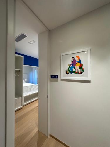a hallway with a painting of two people riding a motorcycle at Le Ciulla Luxury B&B in Pescara