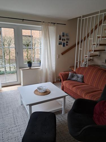 a living room with a couch and a table at FeWo Nordsee Whng 3 in Wangerland