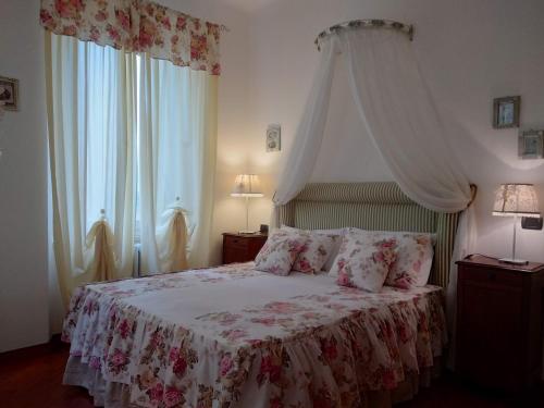 a bedroom with a bed with a white canopy at B&B Palazzo Mestichelli Boutique Palace in Monteprandone