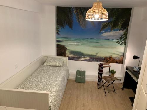 a bedroom with a bed and a painting of the ocean at A 5 minutos andando del Casco Viejo, ayuntamiento, Plaza Circular y Gran Vía de Bilbao y próximo a las 2 líneas de metro in Bilbao