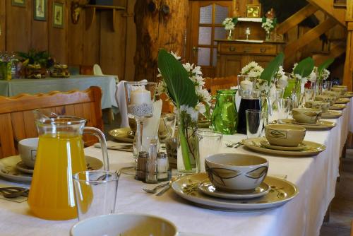 a long table with plates and cups on it at Hotel Protea Bolesławiec in Bolesławiec