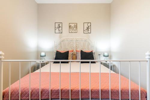 a bedroom with a bed with a metal rail at Iliovasilema Luxury Apartment in Heraklio Town