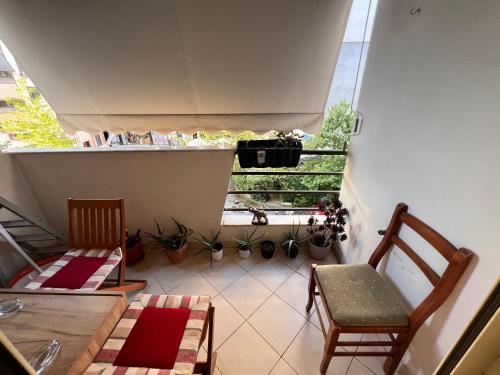 a small room with two chairs and a table and a window at Tirana modern one bedroom Apartment in Kashari