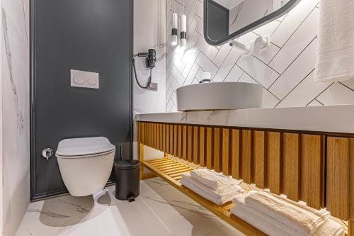 a bathroom with a white toilet and a sink at Dulcet Hotel in Antalya