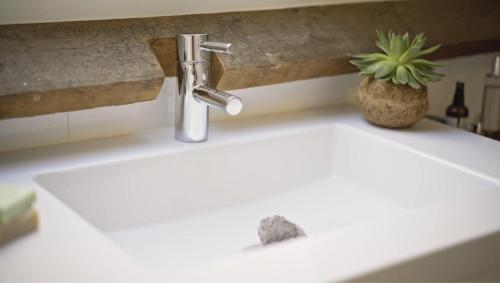 a bathroom sink with a faucet on a counter at RetreatHouse in Lith