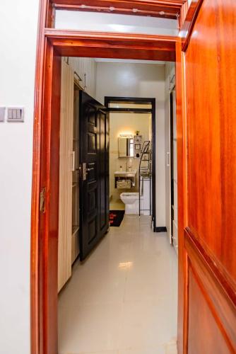 a hallway with a door leading to a bathroom at PNG Guest house Kitende in Kampala