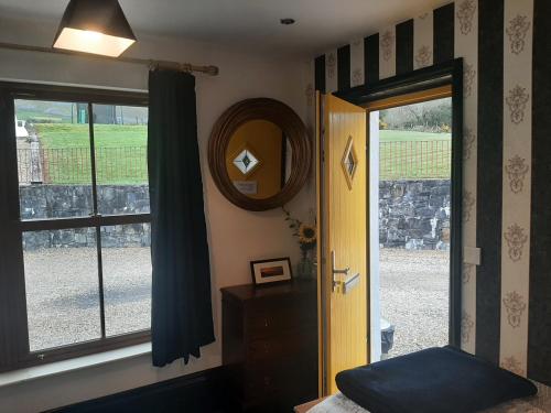 a room with a door and a mirror and a window at Willow Cottage Accommodation in Sligo