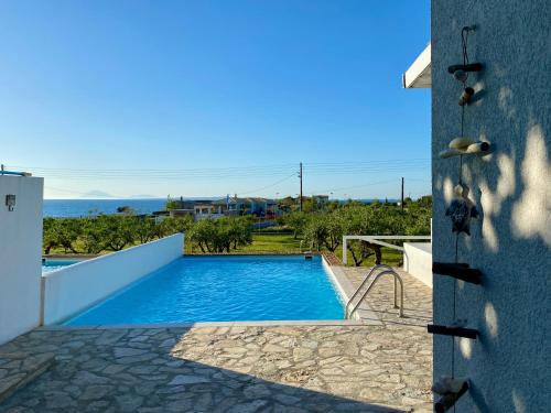 a view of a swimming pool from a house at Betty's Villas in Korakokhórion