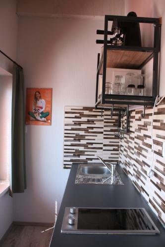 a kitchen with a sink and a counter top at Zamárdi Trafóház in Zamárdi