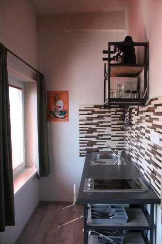 a kitchen with a sink and a counter top at Zamárdi Trafóház in Zamárdi