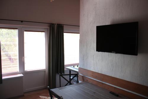 a living room with a flat screen tv on a wall at Zamárdi Trafóház in Zamárdi