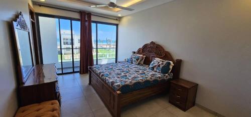 a bedroom with a bed and a large window at SEA VIEW LUXURIEST APARTMENT in Mazizini