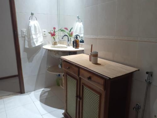 a small bathroom with a sink and a toilet at Aldeia Maravista in Niterói