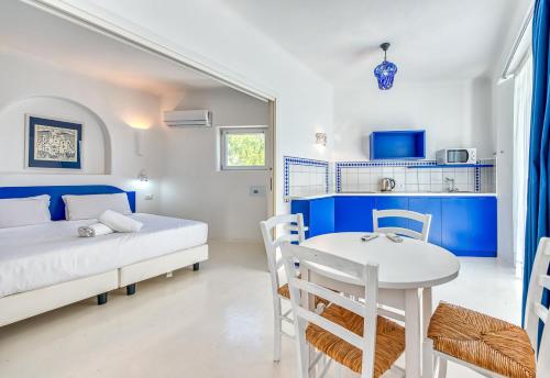 a bedroom with a bed and a table and chairs at Villa Ravino Secret Retreat in Ischia