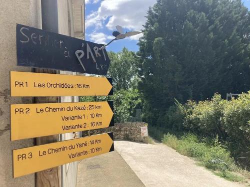 a street sign with a bunch of signs on a building at Appartement village in Simorre