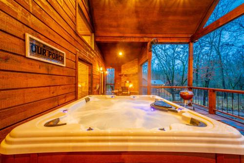 a jacuzzi tub in the middle of a room at The Luxurious Blue Sky Lodge is EPIC! in Broken Bow