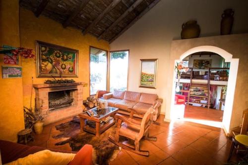 a living room with a couch and a fireplace at Chalet Campestre la Peseta in Ubaté