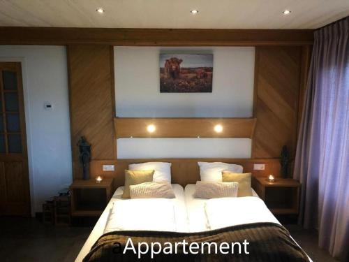 a bedroom with a large bed with white sheets and pillows at de Zeilende kraay in Katwijk