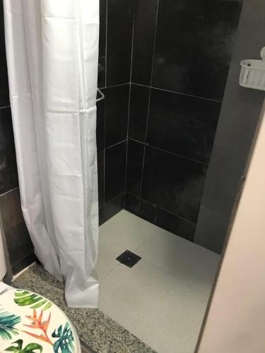 a bathroom with a shower with a tile floor at Alojamiento PlayaArco in Los Escullos