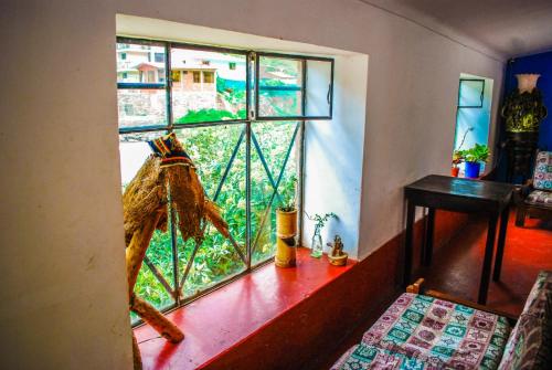 a window in a room with a view of a city at Aguaymanto hostel in Pisac