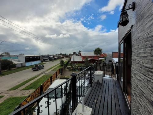 a balcony of a building with a view of a street at Hospedaje Alimar in Frutillar