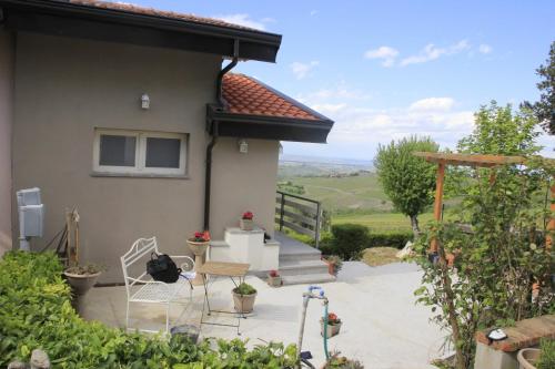 a patio with chairs and a house with a view at NiFe Tiny House - Secret Garden in Montalbo