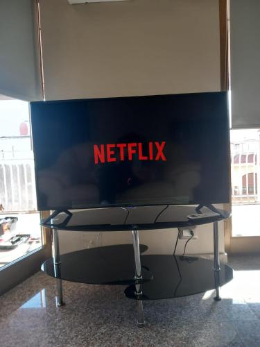 a netflix sign on a table in a room at Bluesky Apartment Naxos 3rd floor in Giardini Naxos