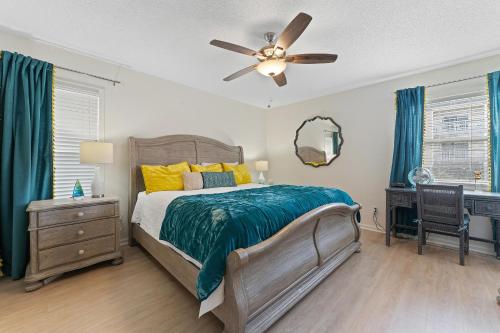 a bedroom with a bed and a ceiling fan at Villas On The Gulf L1- Ocean view steps to beach! in Pensacola Beach