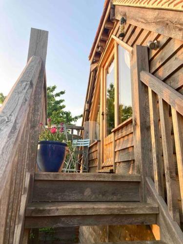 a wooden staircase leading to a house with a potted plant at The Nest BnB 'mini suite' in Dorchester on thames