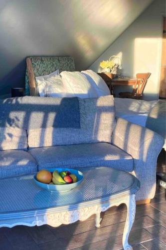 a bowl of fruit on a table next to a couch at The Nest BnB 'mini suite' in Dorchester on thames
