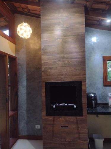a living room with a tv on a wall at CASA PRUMIRIM in Ubatuba