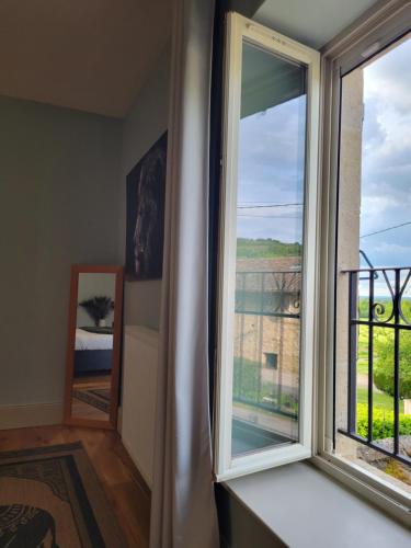 a room with a window and a balcony at Chambre d'hôtes LE FLACON DE LA VERROUILLE in Bruniquel