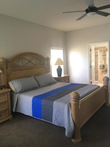 a bedroom with a bed and a ceiling fan at Family Villa with Private Pool near Disney Parks in Kissimmee