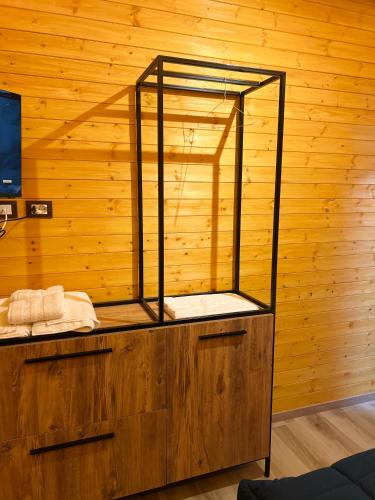 a room with a cage on top of a wooden wall at HOTEL MEGNIAR in Lushnjë