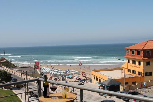 a view of a beach with people and the ocean at Apartment with Breathtaking view in Praia da Areia Branca