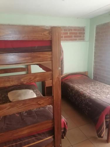a room with two bunk beds and a bed at Cabaña Carretera internacional in Los Andes