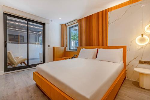 a bedroom with a large bed and a large window at Dulcet Hotel in Antalya