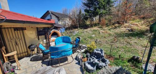 a group of chairs sitting on a patio at Zlatiborska Brvnara Rebic Mountain House in Zlatibor