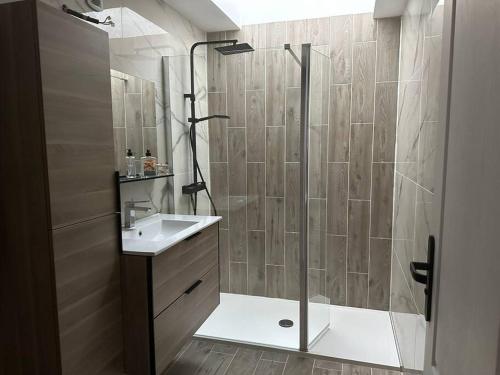a bathroom with a shower and a sink at La Verdière in Cesny-Bois-Halbout