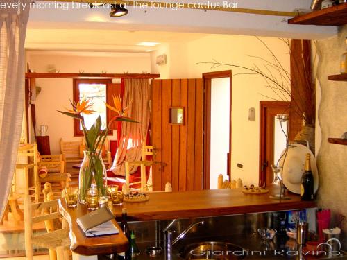 a kitchen with a table and a dining room at Villa Ravino Secret Retreat in Ischia