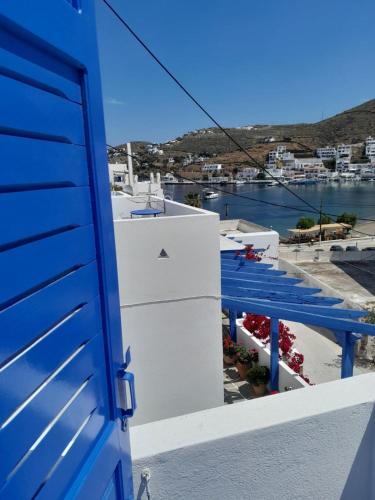 a blue door on a building with a view of a harbor at Martinos Studios, Merihas port in Kithnos