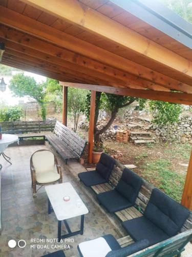 a patio with a couch and chairs and a table at Balcony view in Gjilek